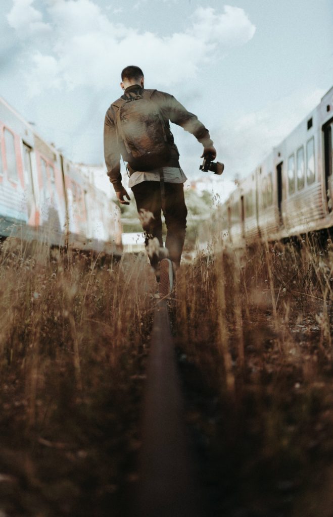 man walking on an old railway