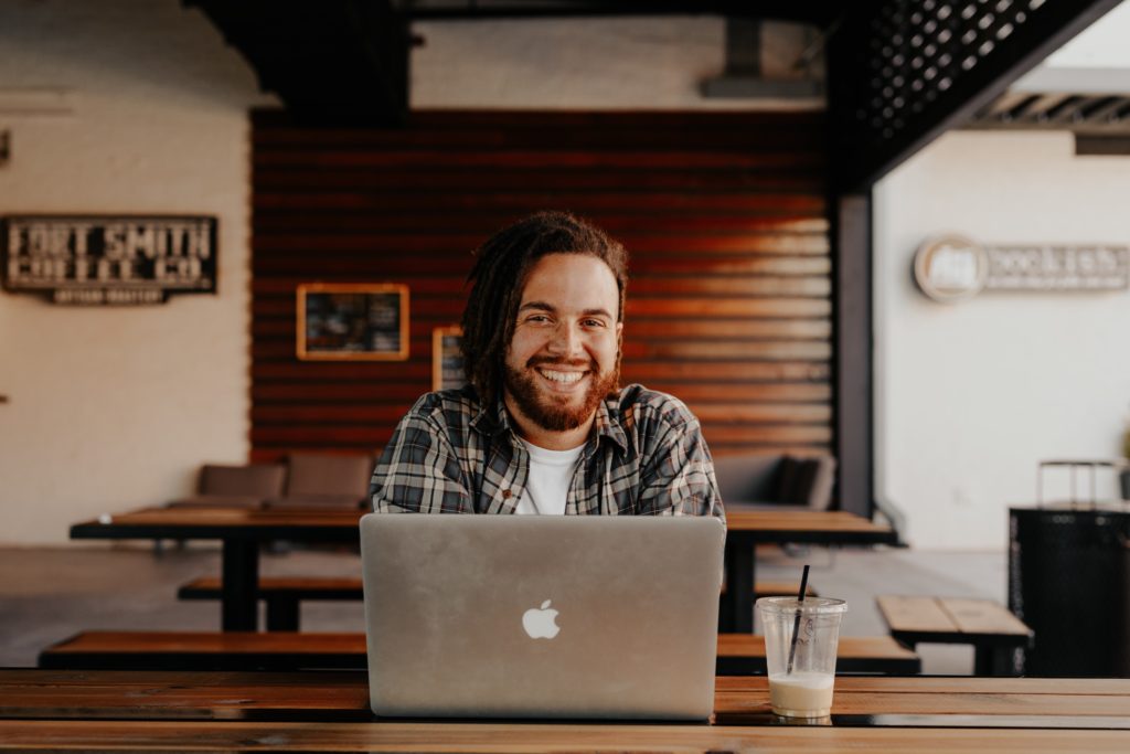 Man with his laptop smiling